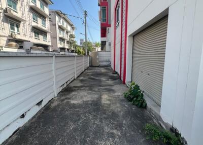 Narrow driveway between buildings with gated area