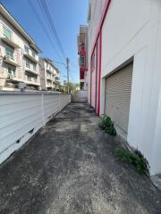 Narrow driveway between buildings with gated area