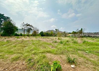 Spacious open land with potential for development under a bright blue sky