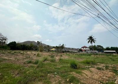 Spacious unfurnished outdoor land area with potential for development under a clear blue sky