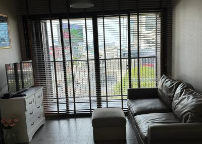 Modern living room with large windows and comfortable seating