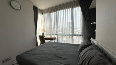 Modern bedroom with large windows and city view