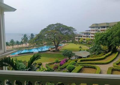 Oceanfront resort view with landscaped garden and pool