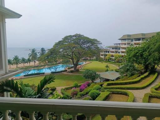 Oceanfront resort view with landscaped garden and pool