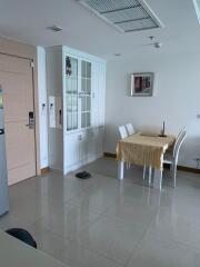 Minimalist dining area with white cabinetry and tiled flooring