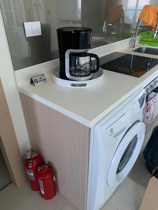 Modern kitchen with coffee maker and washing machine