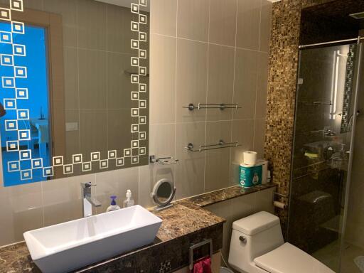 Modern bathroom with detailed tile work and upscale fixtures