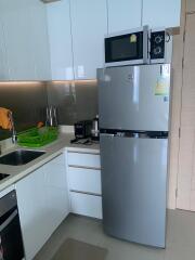 Contemporary kitchen with stainless steel appliances and ample storage space