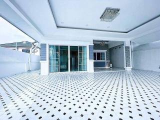Spacious white balcony of a modern residence with intricate floor tiling
