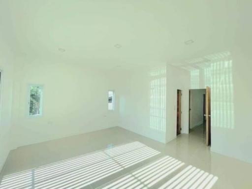 Bright and spacious empty living room with large windows