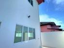 White two-story building exterior with clear sky