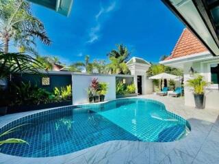 Private swimming pool with tropical landscaping in a residential property