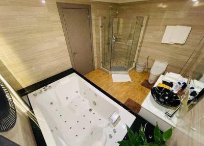 Modern bathroom with a jacuzzi tub, walk-in shower, and luxury finishes