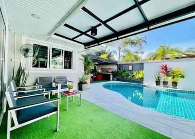 Spacious outdoor area with swimming pool and lounge seating