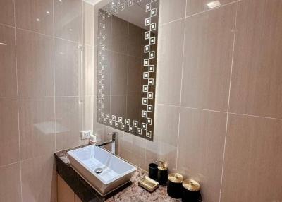 Modern bathroom with marble countertops and LED mirror