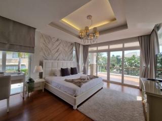 Spacious master bedroom with modern design and ample natural light