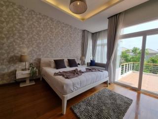 Spacious bedroom with modern design, king-size bed, and balcony access