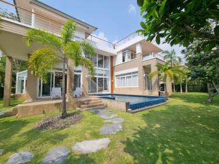 Modern two-story house with a swimming pool and landscaped garden