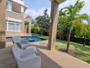 Spacious backyard with a swimming pool and comfortable patio furniture