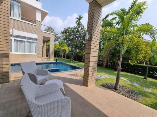 Spacious backyard with a swimming pool and comfortable patio furniture