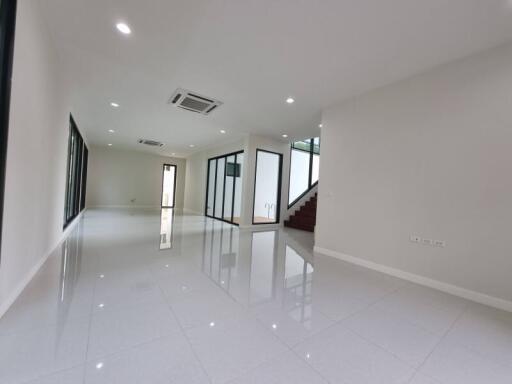 Spacious and well-lit empty interior space with reflective flooring