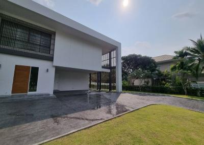 Modern house exterior with spacious driveway and green lawn