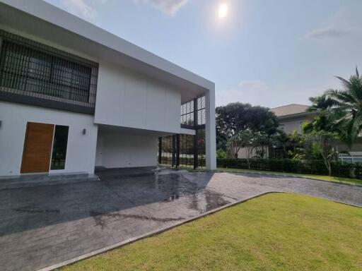 Modern house exterior with spacious driveway and green lawn