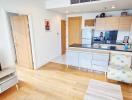 Comfortable living room with modern open kitchen, wooden flooring, and natural light