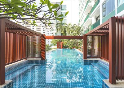 Inviting residential swimming pool with surrounding greenery and modern architecture