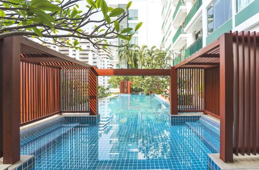 Inviting residential swimming pool with surrounding greenery and modern architecture