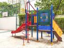 Colorful children's playground equipment in an outdoor area with greenery