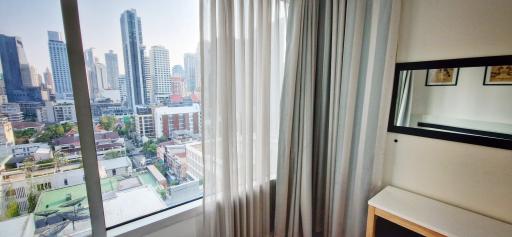 Modern bedroom with city view and natural light