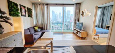 Modern living room with city view and adjacent bedroom space