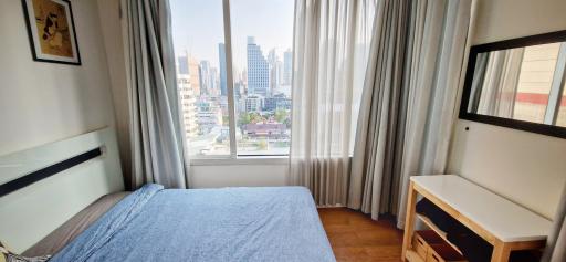 Cozy bedroom with city view and natural light