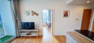 Bright and modern living room with a flat-screen TV and balcony access