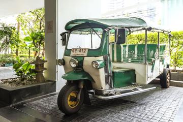 Thailand traditional tuk tuk parked in building entrance