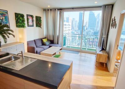 Modern apartment interior with open-plan kitchen and living room, city view