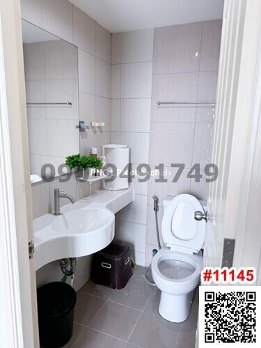 Modern white bathroom with sink, toilet, and shower area