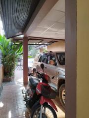 Carport with parked car and motorcycle