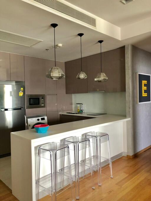 Modern kitchen with stainless steel appliances and breakfast bar