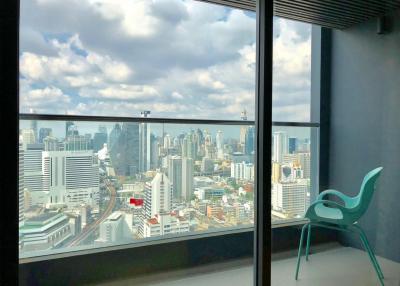 Room with panoramic city view through large windows