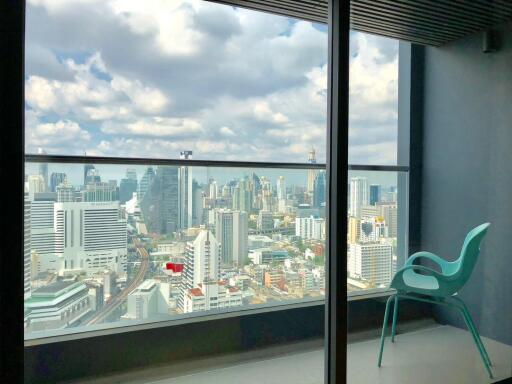 Room with panoramic city view through large windows