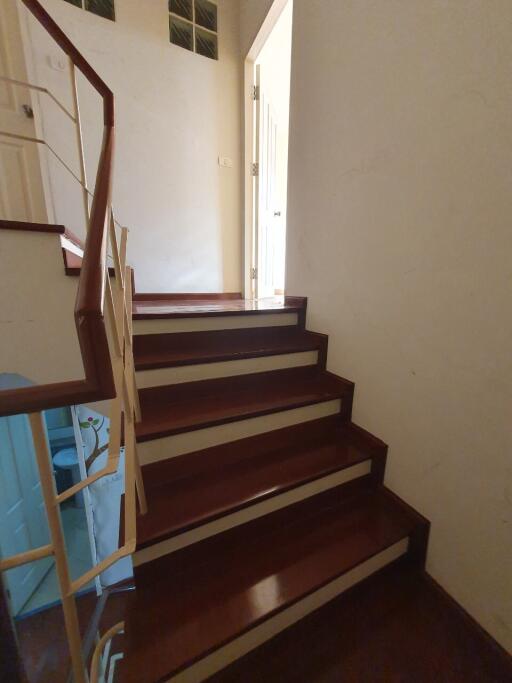 Wooden staircase leading to an upper level of a house