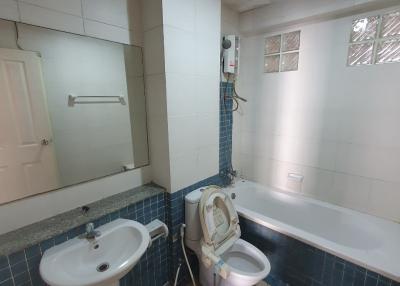 Spacious bathroom with a sink, toilet, and bathtub
