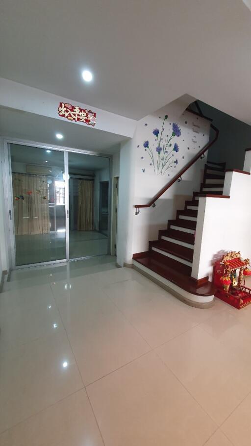 Bright and spacious home entryway with staircase and access to living areas
