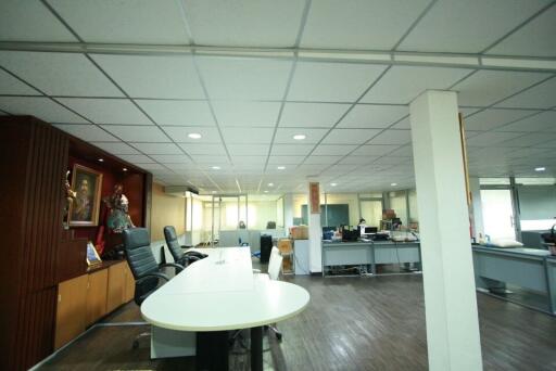 Spacious open-plan office interior with workstations and bright lighting