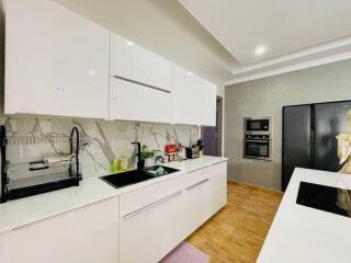 Modern kitchen with white cabinetry and stainless steel appliances