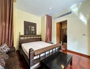 Elegant bedroom with polished wood flooring and traditional decor