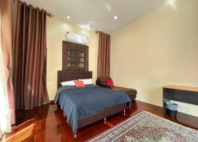 Cozy bedroom with wooden flooring and elegant decor