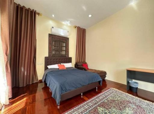 Cozy bedroom with wooden flooring and elegant decor